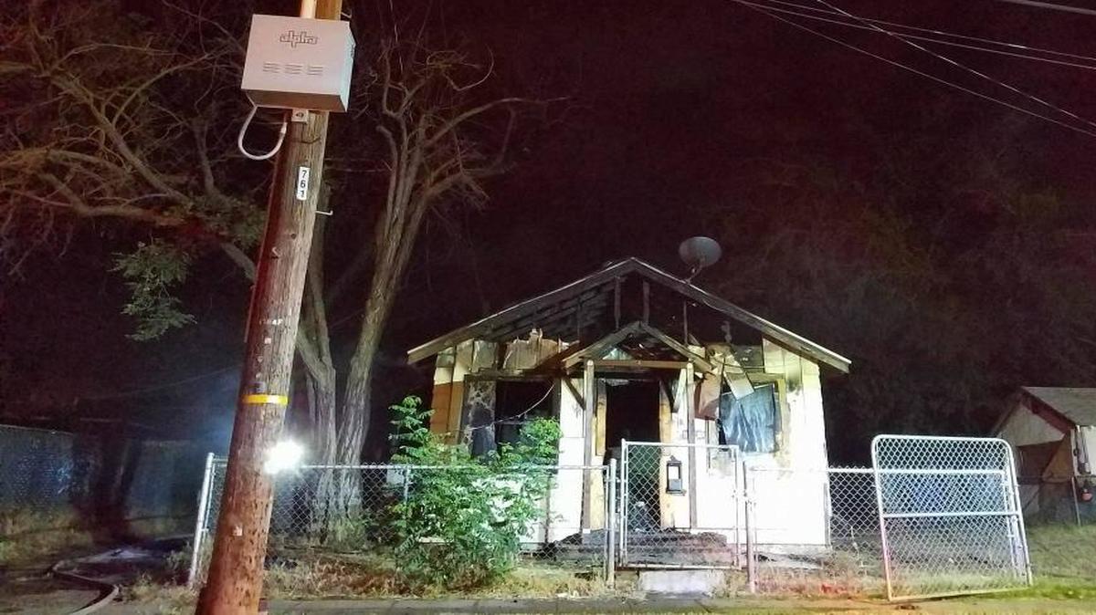 A power line dropped on the roof of a home in southeast Fresno during a fire that injured one woman on Tuesday, May 9, 2017. The fire is under investigation and is considered suspicious, according to Fresno fire battalion chief Tony Escobedo.