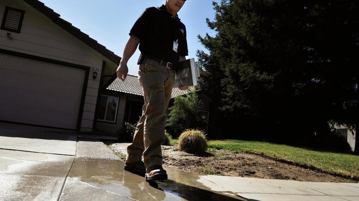 
Water patrols have been finding illegal watering for several years in Fresno. Tou Moua, Fresno water conservation representative, last year wrote a notice of violation at this home.
