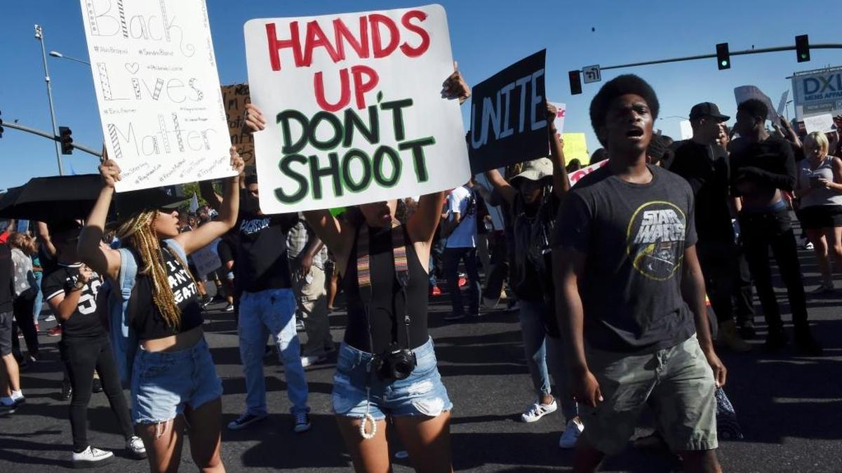 Protesters shut down the Blackstone and Shaw Avenue intersection after a crowd gathered to protest recent officer-involved shootings throughout the country on Saturday evening, July 9, 2016 in Fresno, Calif.