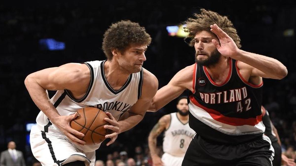 
Brooklyn Nets center Brook Lopez drives at his twin brother, Portland Trail Blazers center Robin Lopez, in an April 2015 game. In the offseason, Robin joined the New York Knicks.
