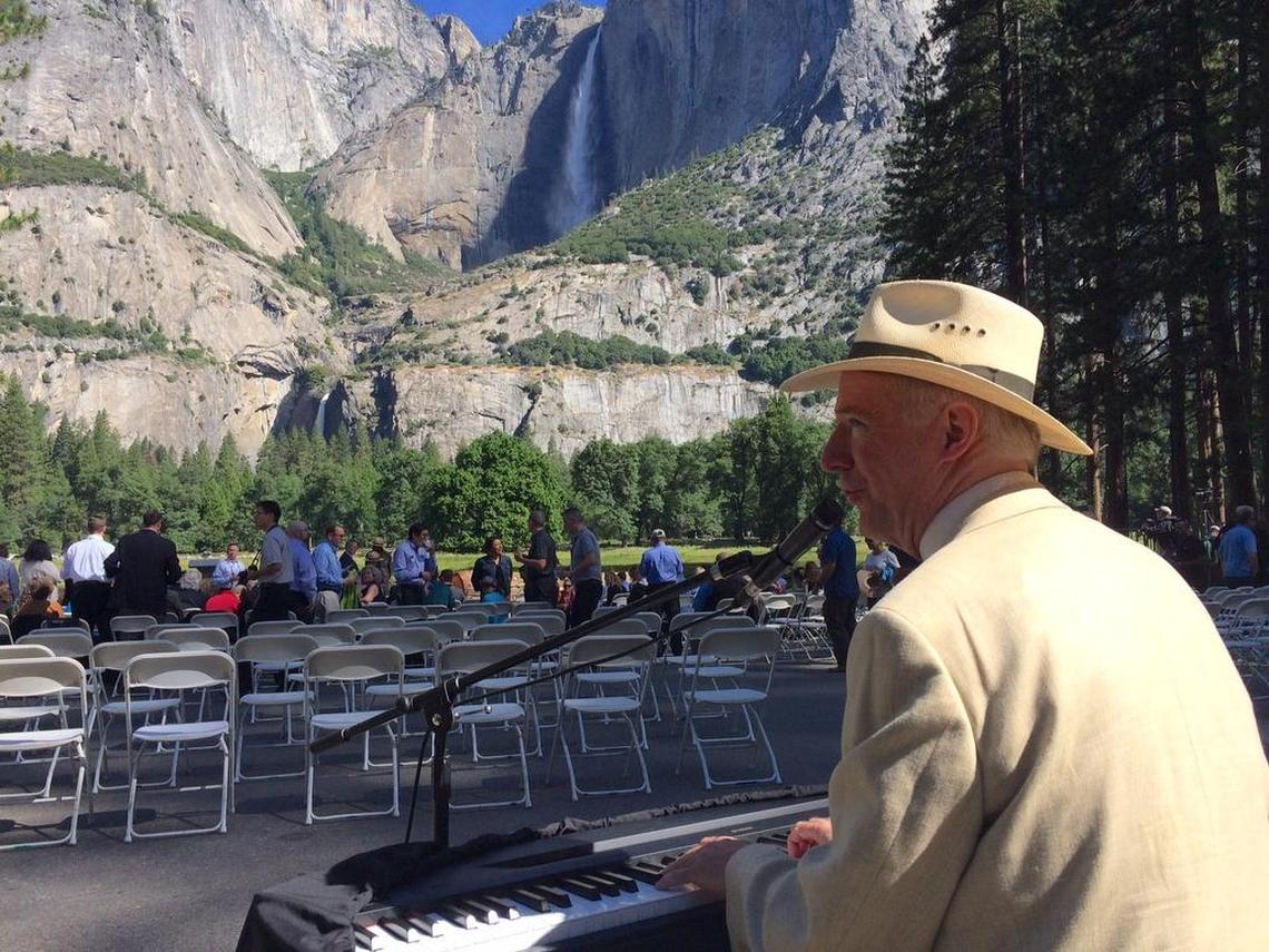 Tom Bopp, who has played piano at the Wawona Hotel and The Ahwahnee since 1983, plays tunes as media and guests assemble for President Barack Obama’s remarks Saturday, June 18, 2016, in front of Yosemite Falls in Yosemite National Park.