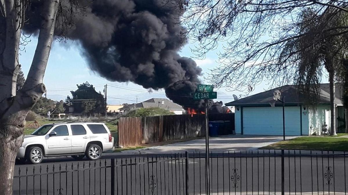 Smoke from big rig that caught on fire in Reedley on Saturday, Jan. 27, 2018 can be seen from a neighborhood. The big rig was a total loss, Battalion Chief Justin Watson said.
