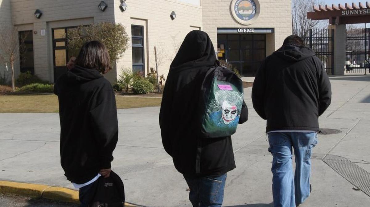 Two truant juveniles are led back to Sunnyside High School by a campus safety assistant in 2008.