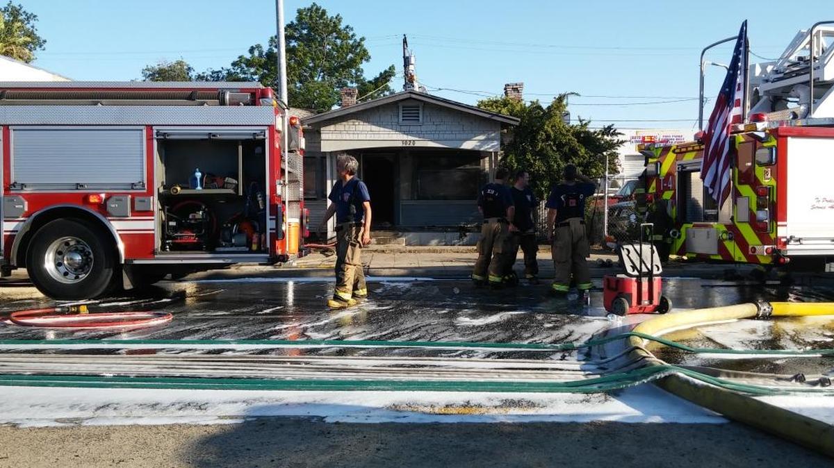 Fresno fire crews wrap up a firefighting operation at an abandoned home in southeast Fresno Monday.
