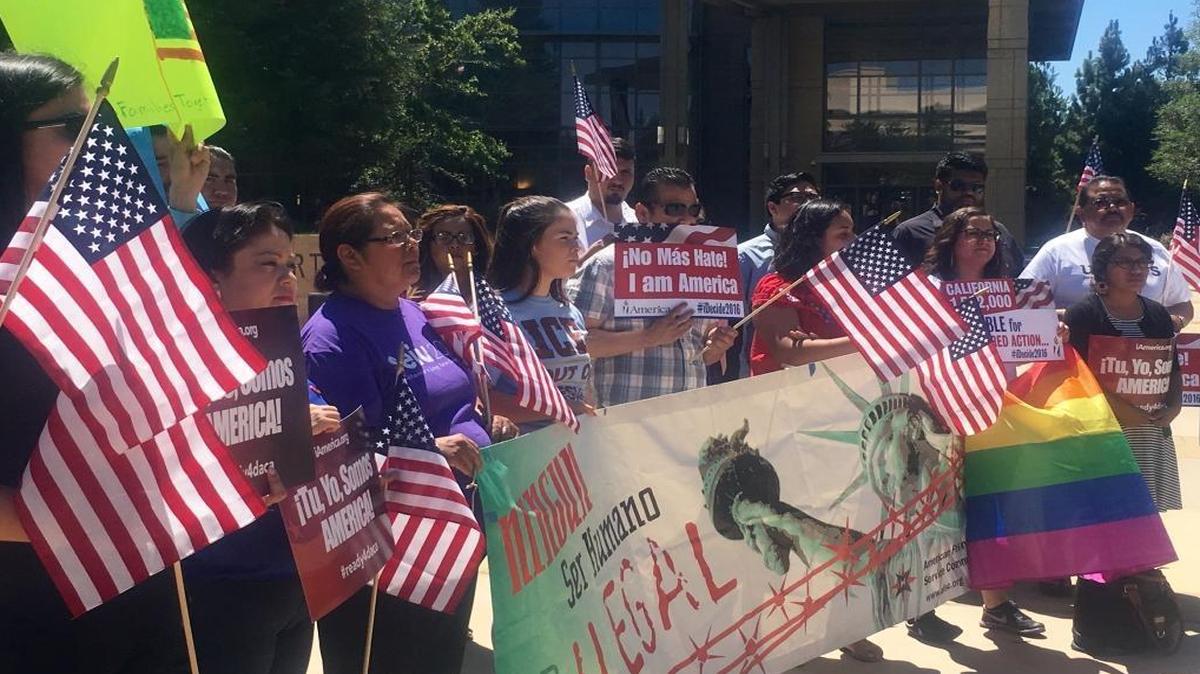 Immigrant advocates stand outside Robert E. Coyle Federal Building in Fresno Thursday to rally against the U.S. Supreme Court’s decision on the Obama administration’s immigration plan.