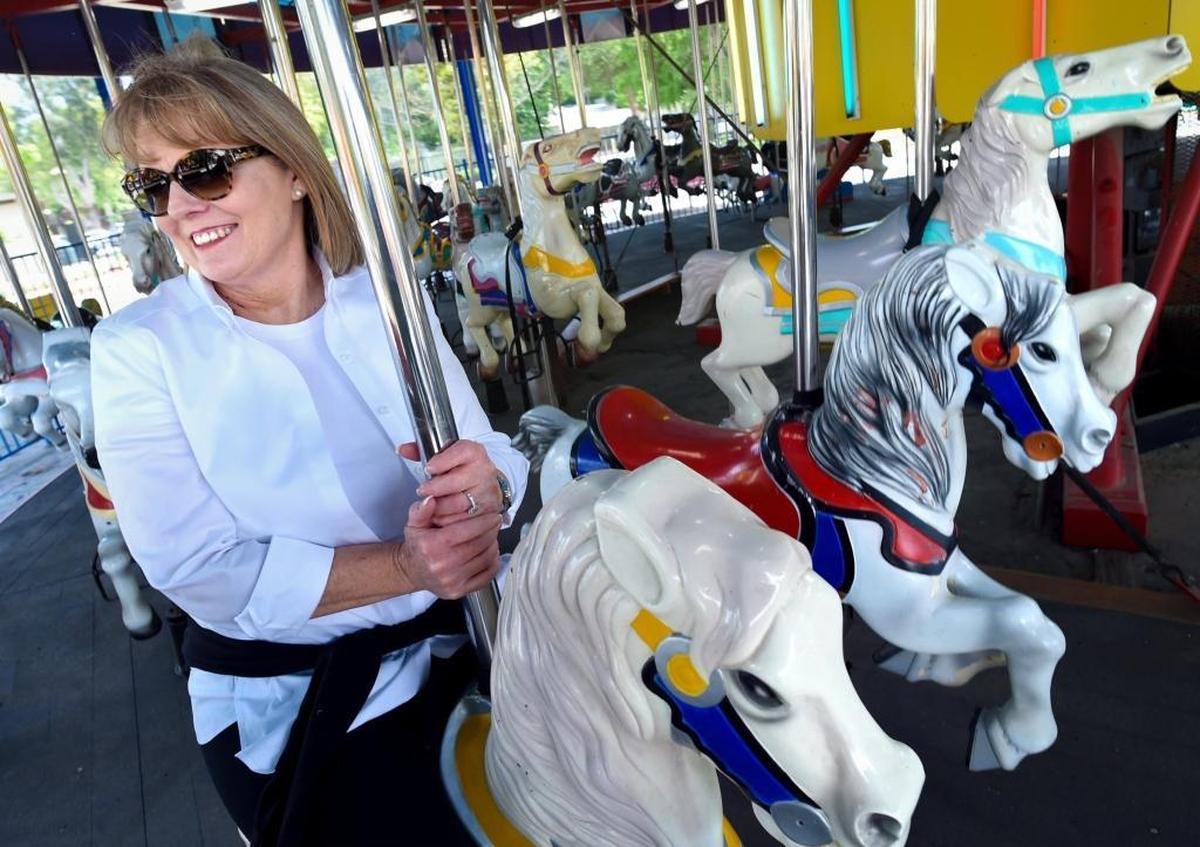 Rotary Playland’s Wendy Batti takes a trial spin on the merry-go-round.