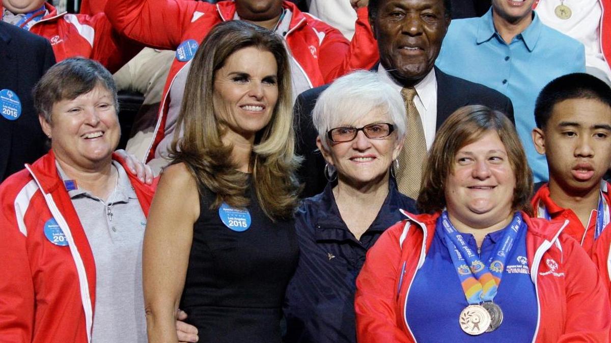 Maria Shriver, second from left, daughter of Special Olympics founder Eunice Kennedy Shriver, is joined by Olympians Rafer Johnson, in suit, and Ann Meyers Drysdale, top right, in a group photo with red-jacketed Special Olympics athletes at a news conference in 2011.
