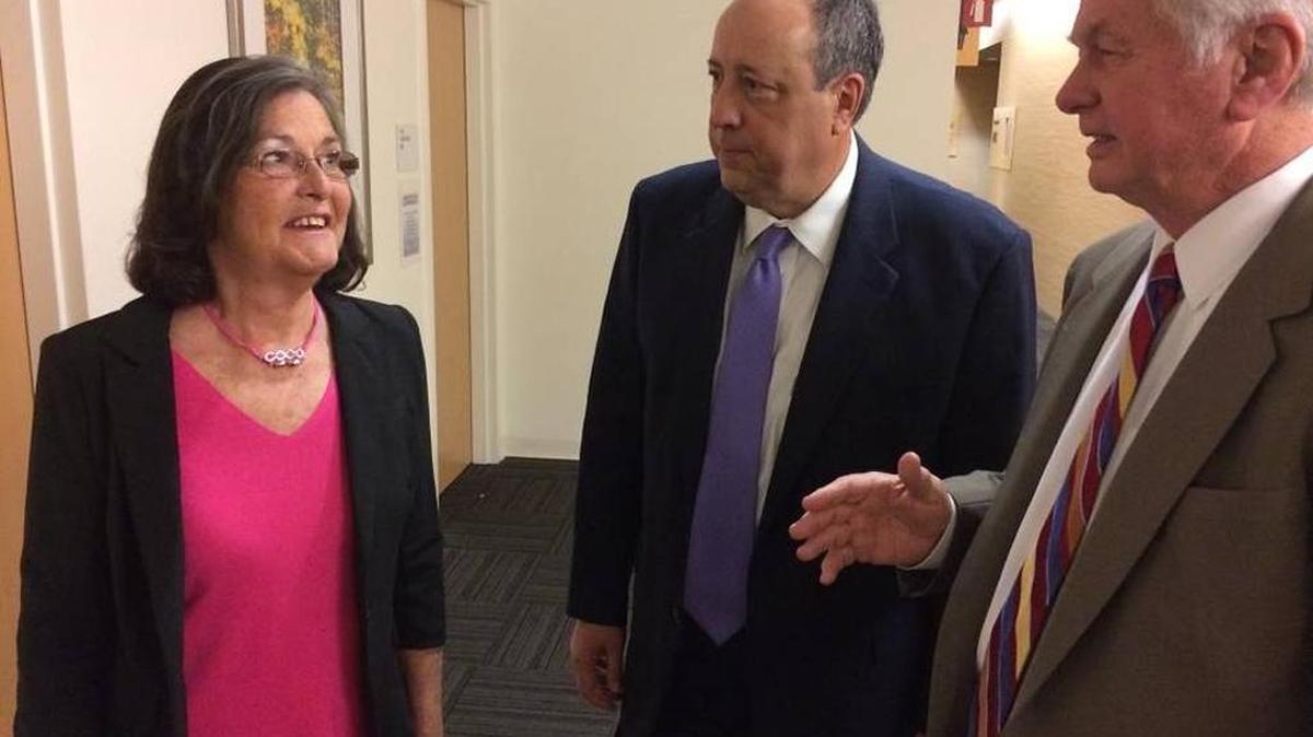 Barbara Barkley talks with her lawyers, Todd Barsotti, center, and Stephen Cornwell, during a break in her wrongful termination civil trial in Fresno County Superior Court. Barkley has sued Bank of the West for age discrimination, harassment and retaliation.
