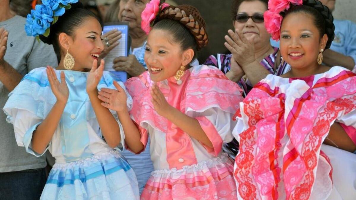 Teocalli Cultural Academy members, from left, Krystal Ramos, Casandra Hernandez, 11, and Leanne Oliva, 12, all of Fresno, watch from the sidelines at the Cinco de Mayo Festival at Courthouse Park on Sunday in downtown Fresno.