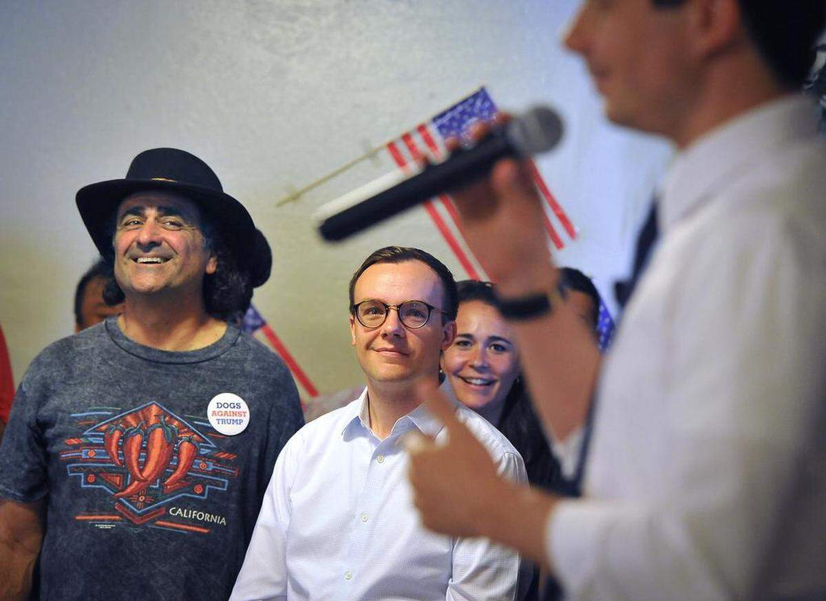Daniel Schwartz, left, and Chasten Buttigieg, center, husband of Democratic presidential candidate Pete Buttigieg, listen to the candidate’s talk to folks gathered at Tuolumne Hall in downtown Fresno on Monday morning, June 3, 2019.
