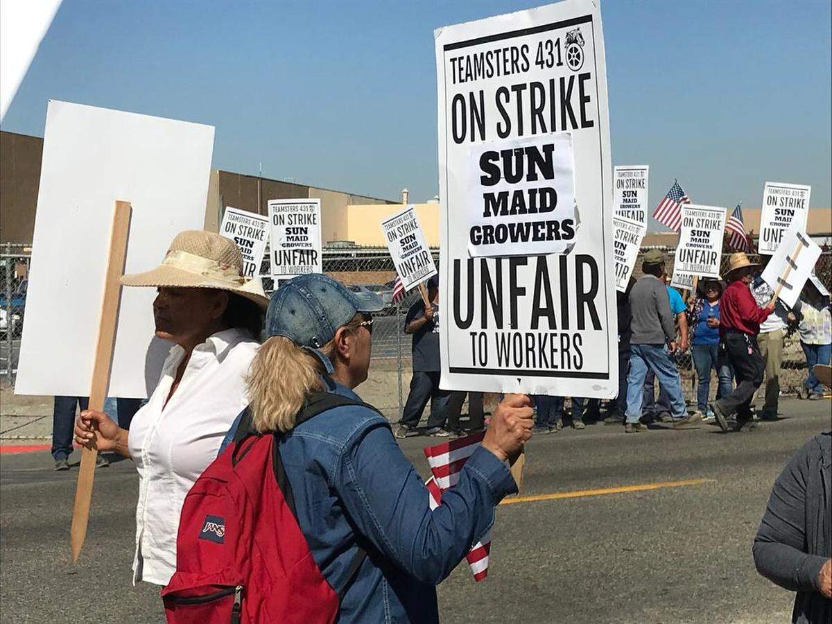 Workers strike outside the Sun-Maid plant in Kingsburg on Tuesday.