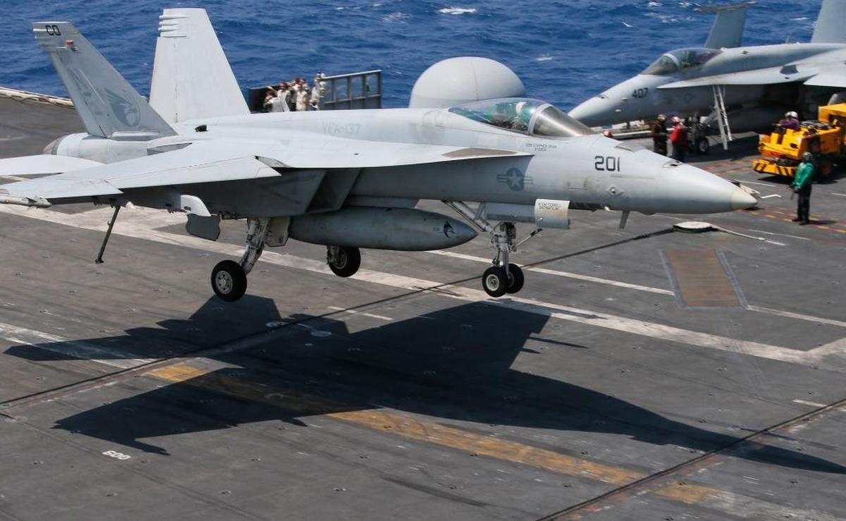 In a March 2017, file photo, a Navy F18 fighter jet lands on the USS Carl Vinson following a routine patrol in the disputed South China Sea, off the Philippines. The aircraft carrier was heading toward the Korean Peninsula. About 700 sailors from Naval Air Station Lemoore are aboard the Vinson.