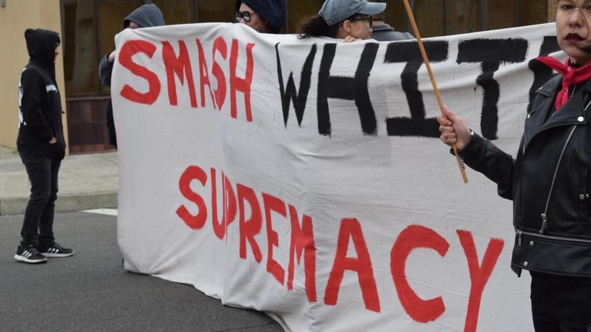 Protesters on Sunday, March 5, 2017, hold a banner blocking M Street at Mariposa Street during a demonstration against Immigration and Customs Enforcement working with the county in the jail.