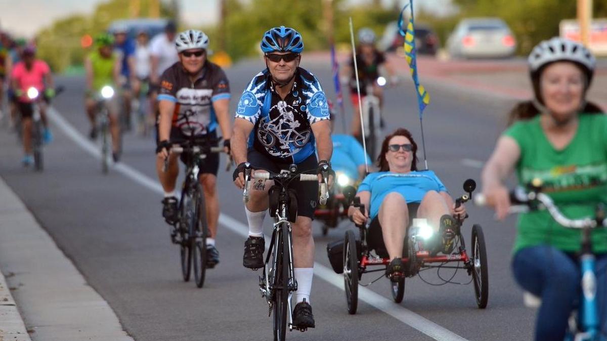 Riders take part in the "Ride of Silence" that honors the memories of cyclists killed by automobiles, on Wednesday, May 18, 2016, in Fresno.