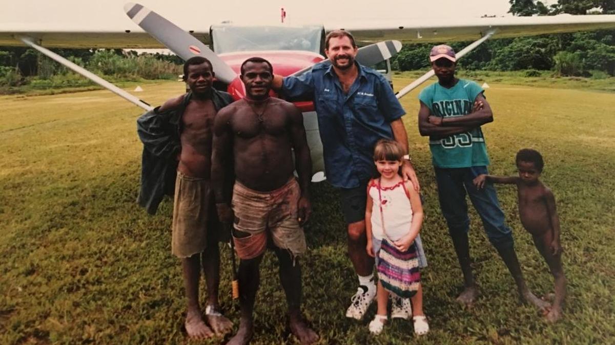 Douglas Harrison with daughter Krista and several locals while he was working as a missionary pilot on the island of of Papua New Guinea.