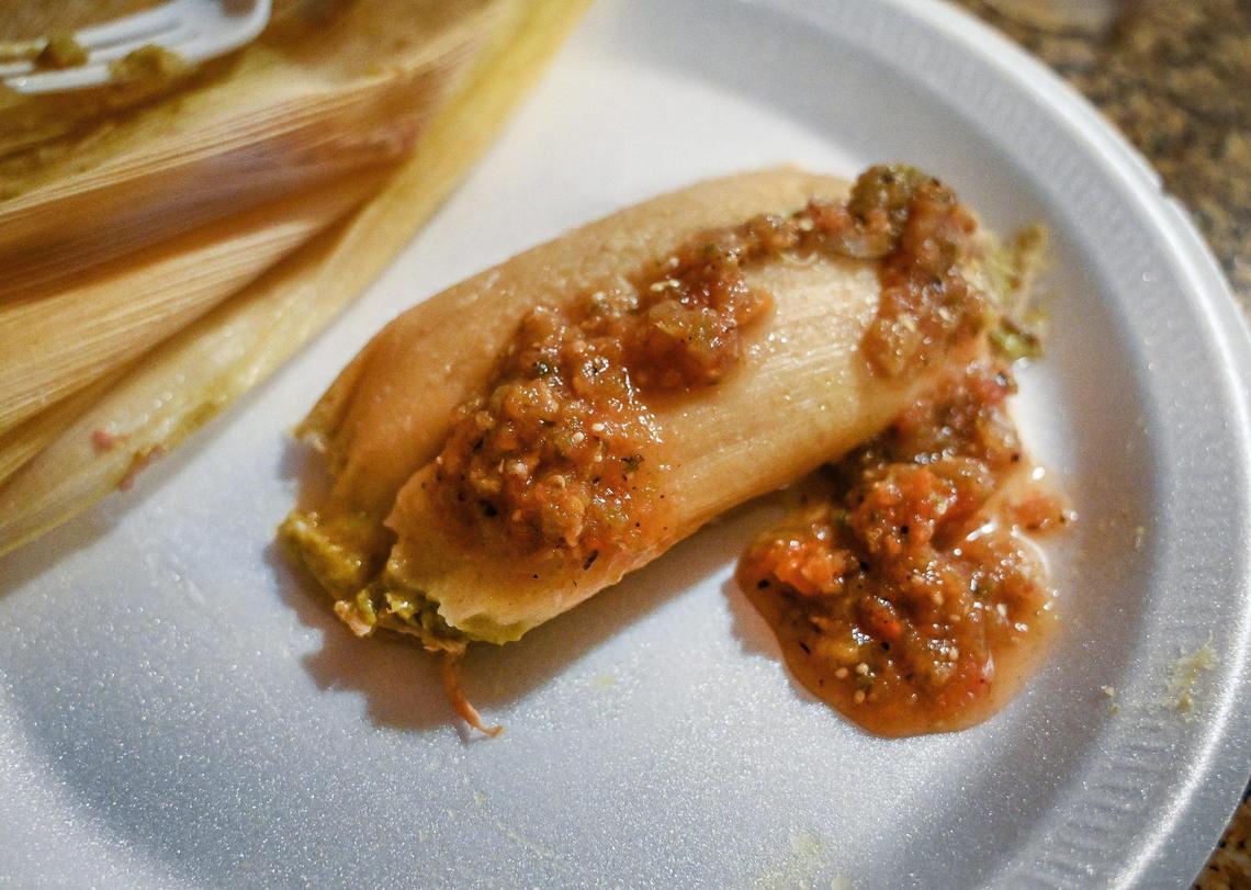 One of Cristina Leon’s tamales sits on a plate with her homemade salsa in her son’s kitchen in Fresno on Friday, Dec. 17, 2021.