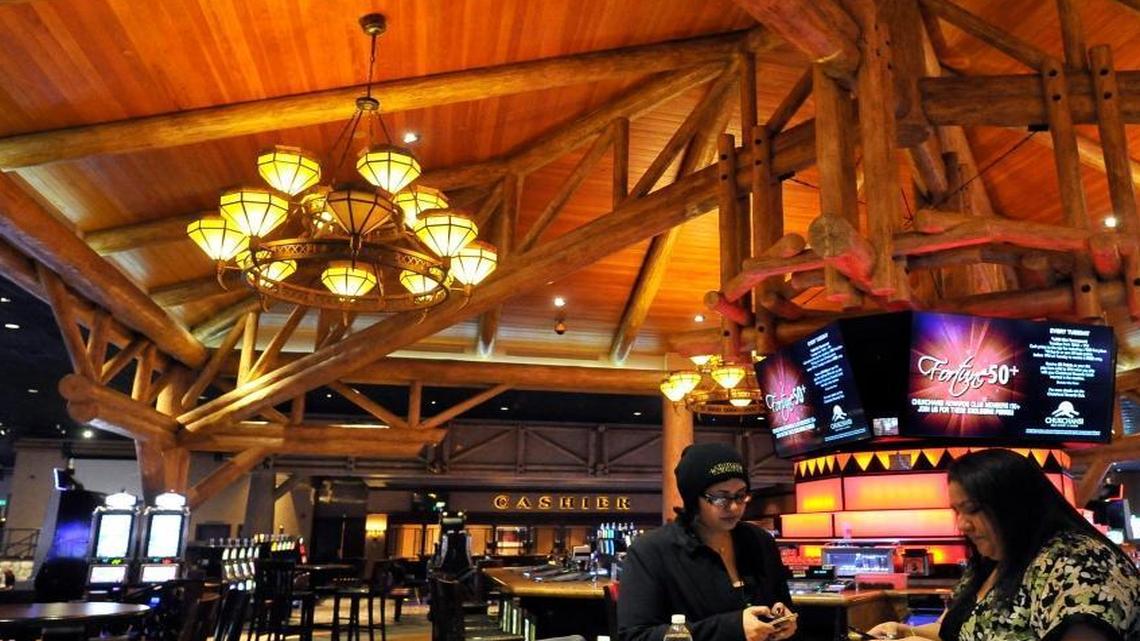 Chukchansi Gold Resort and Casino employees Samira Zadsalamat, left, and Rachel Reid, right, prepare the Center Bar for the reopening Thursday.