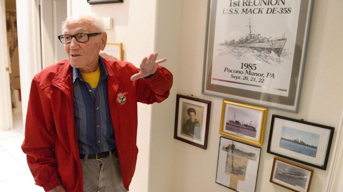 Fresno resident and Pearl Harbor survivor Joe Quercia stands by photos and memorabilia in the hallway of his home as he tells stories about his time in the service. He was aboard the USS Medusa during the surprise attack of Dec. 7, 1941.