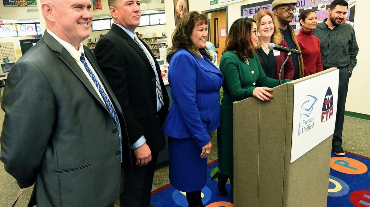 In this file photo Bob Nelson, Superintendent for Fresno Unified, left, beams as Elizabeth Jonasson Rosas, at podium, announces the agreement reached between Fresno Unified and Fresno Teachers Association, during a press conference at Leavenworth Elementary, Wednesday afternoon, Jan. 17, 2018. On Wednesday, Feb. 7, 2018, Fresno Unified’s board approved the agreement.