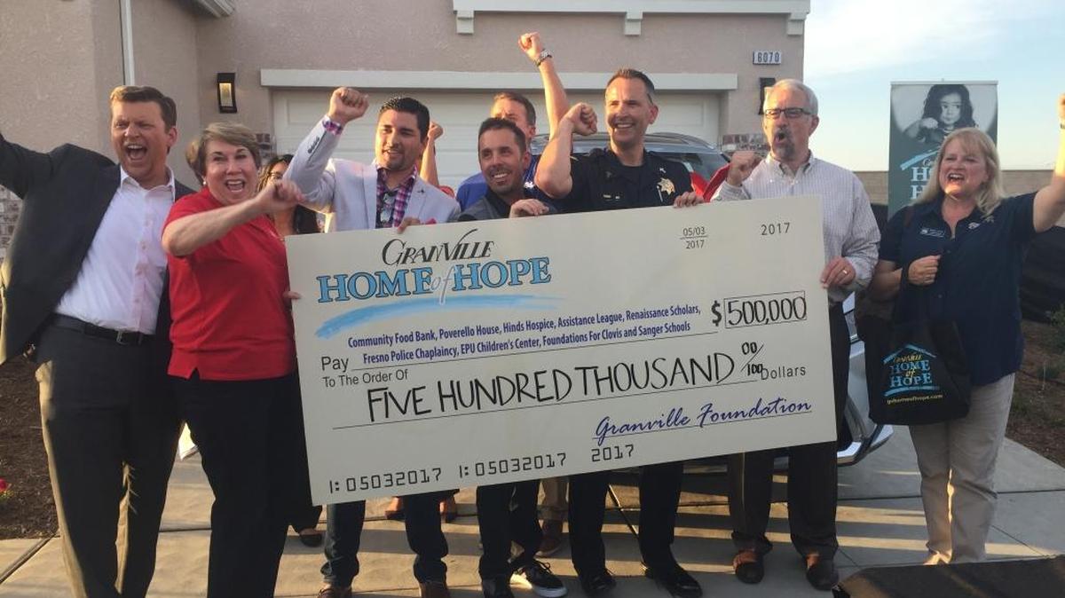 Representatives from local non-profits received a check Wednesday after raising $500,000 through the Granville Hope of Home raffle.