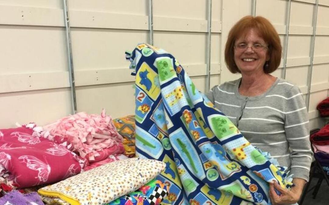 Project Linus volunteer Michele Shields displays a blanket made for local children.