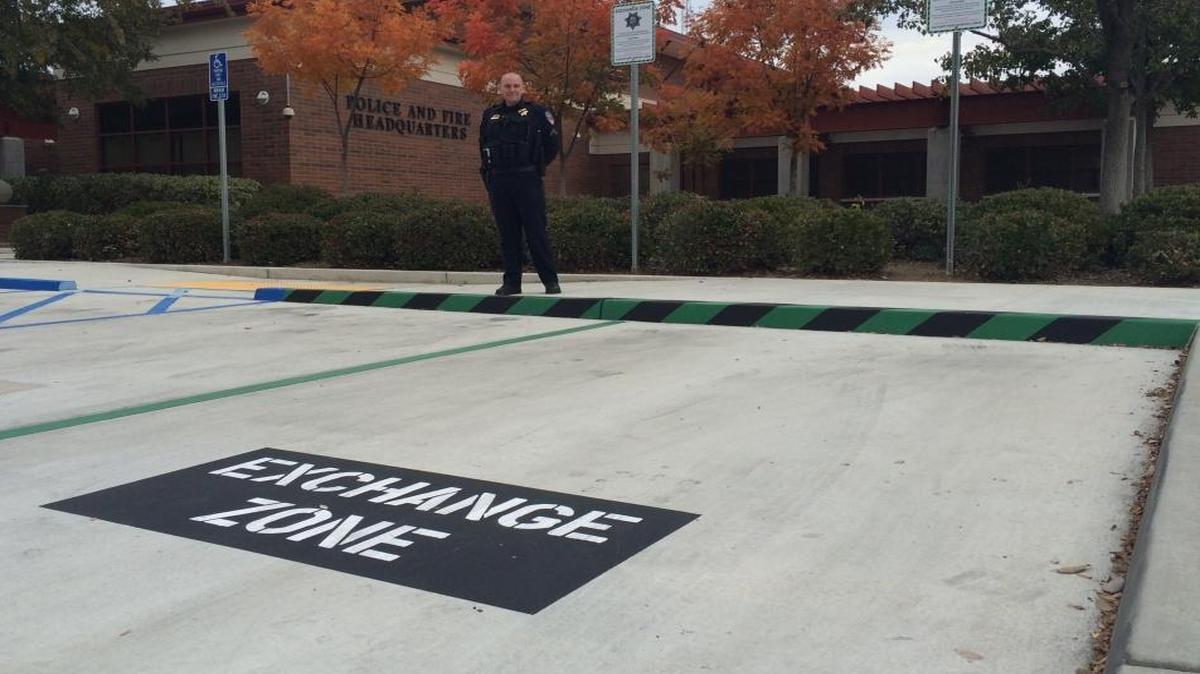 Clovis Police Cpl. Jared Binford stands near the department’s Exchange Zone, where anyone can meet to conduct sales through Craigslist, eBay and classified ads in a well-lit area under video surveillance.