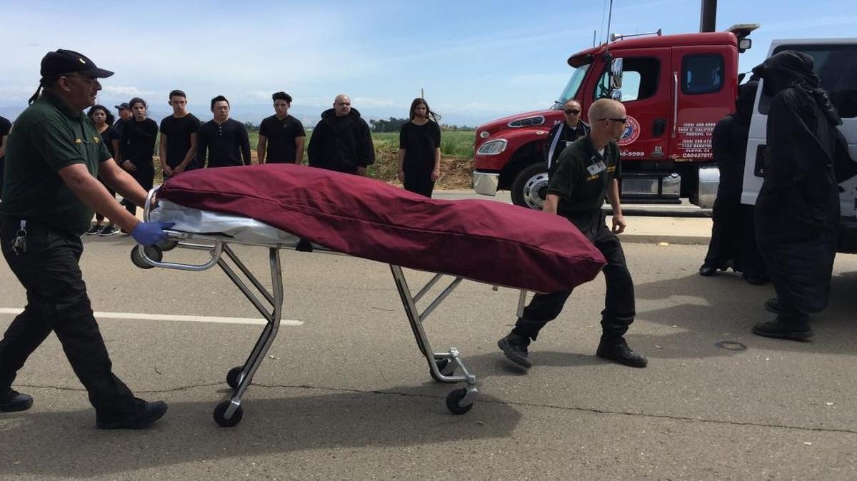 Clovis East student Ryan Odom is wheeled away under a sheet and loaded into a corenor’s van. Odom was role-playing a student who dies in a drunk driving crash as part of a recent Every 15 Minutes program hosted by the California Highway Patrol.