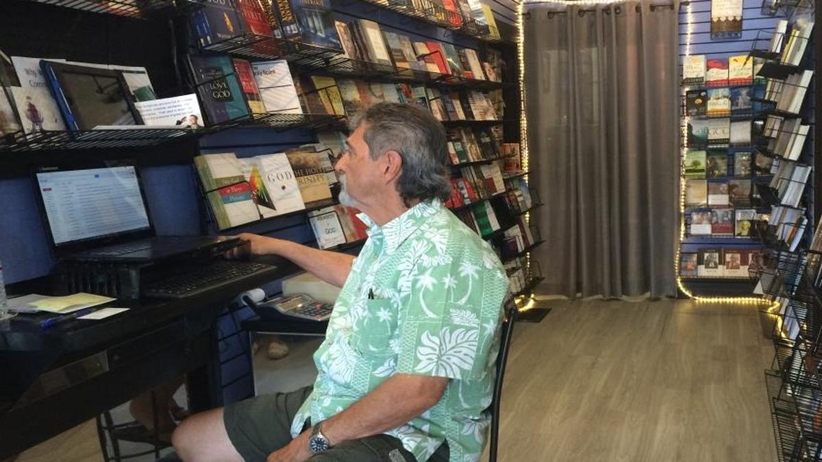The Book Nook owner Ed Flores orders titles for his Christian bookstore in Old Town Clovis.