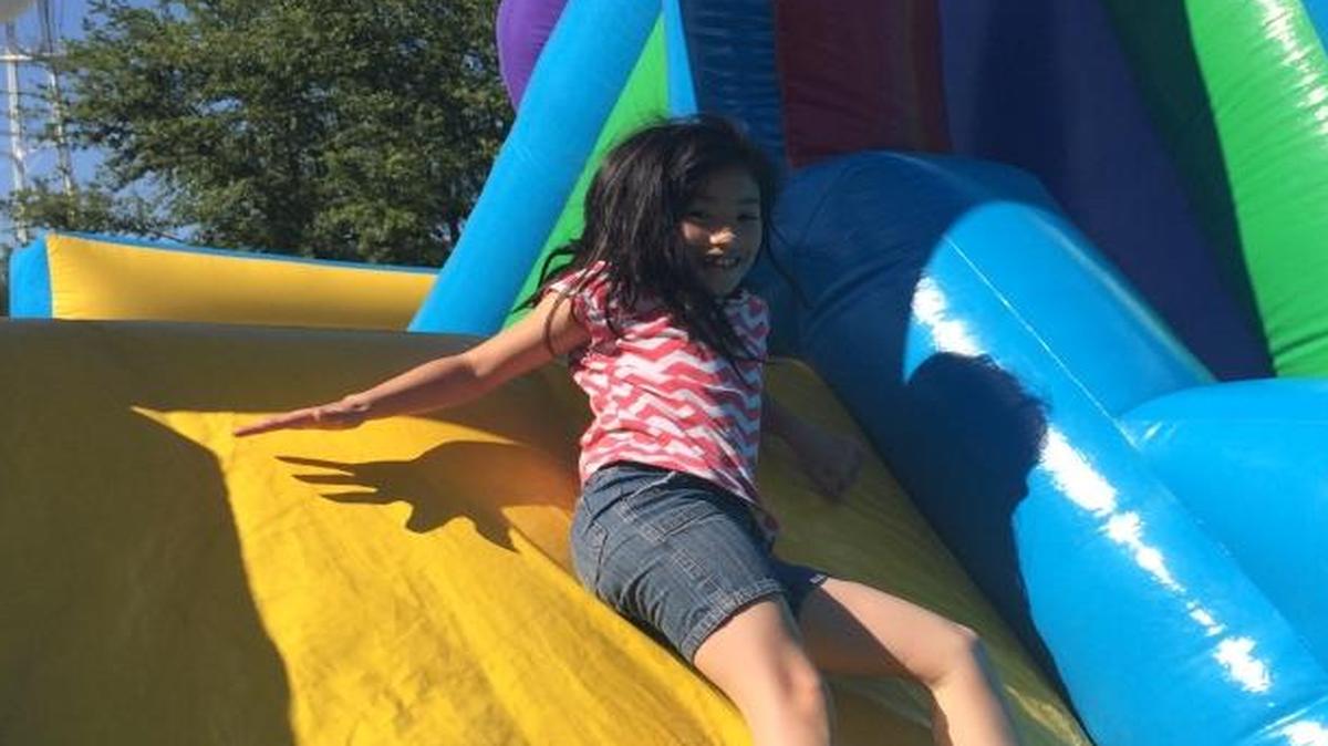 Lilly Regalbuto, 8, slides in an obstacle course near Clovis Veterans Memorial District.