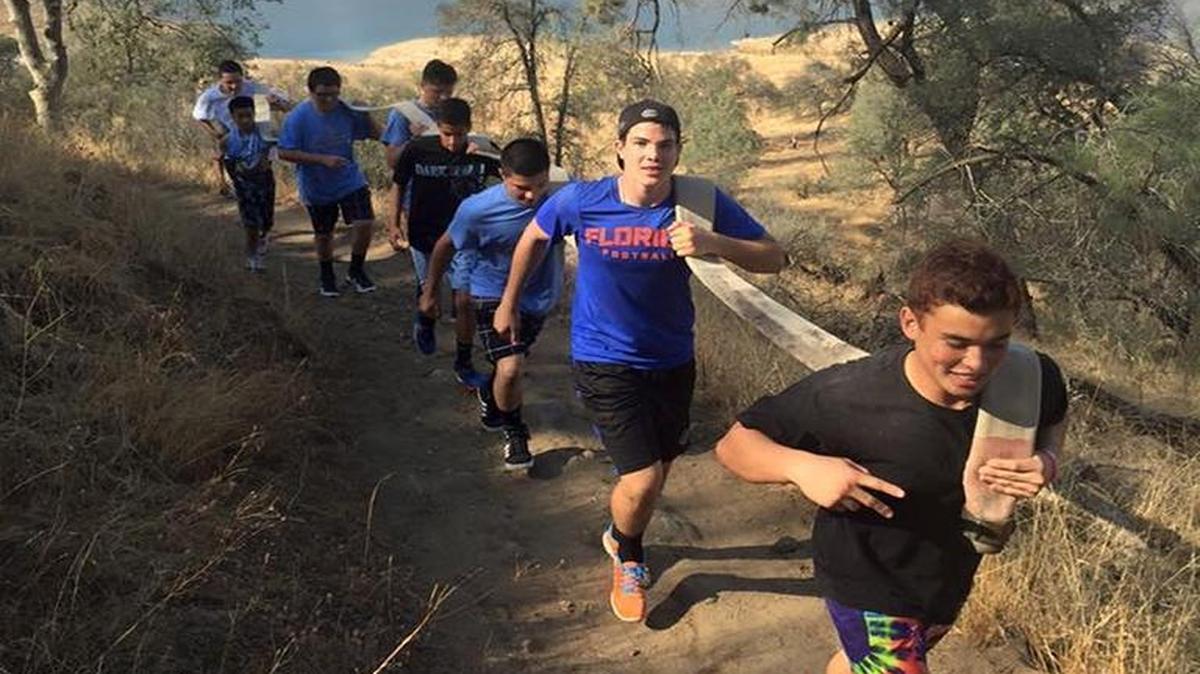 Men’s Alliance Program participants held a fire hose while they hiked the San Joaquin River Trail last month for team-building exercises.