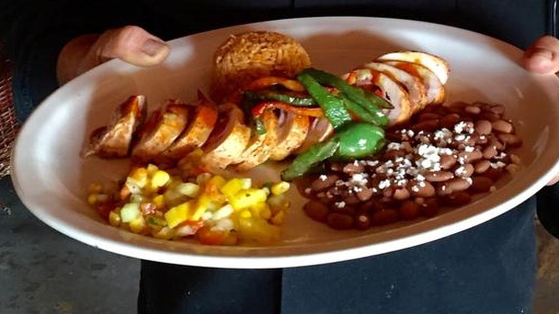 Fernando Madrigal displays one of his specialty dishes — Pechuga Don Fernando’s — at his restaurant, Don Fernando’s Mexican Cuisine. The Pechuga is a chicken dish.