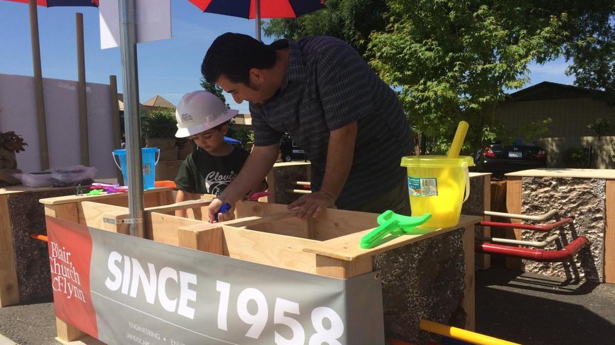 Robert Francis and Frank Francis, 4 play in the “Consulting Engineers” parklet created by Blair, Church & Flynn.