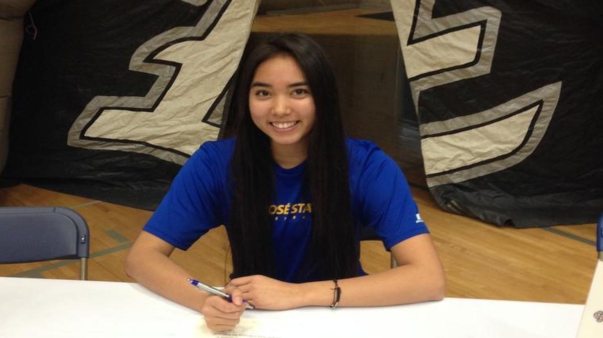 Thaliana Grajeda, a senior at Clovis East High School, signs on to play volleyball at San Jose State University last week at her signing party.