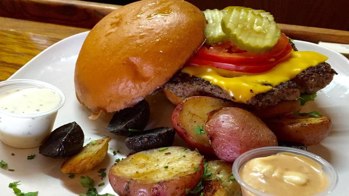
A Betsy Ross burger is served with roasted potatoes, one of several side choices available on the menu.
