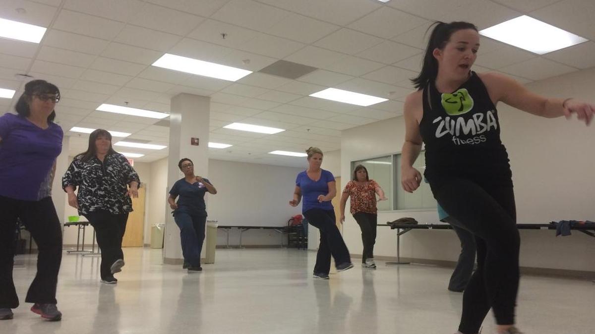 Kaiser Permanente Clovis employees participate in a lunchtime Zumba class led by senior health educator Candice McAleavey, right, as part of the Pound For Pound Challenge. For every pound of weightloss recorded by the employees, one pound of produce will be donated to the nonprofit Feeding America.