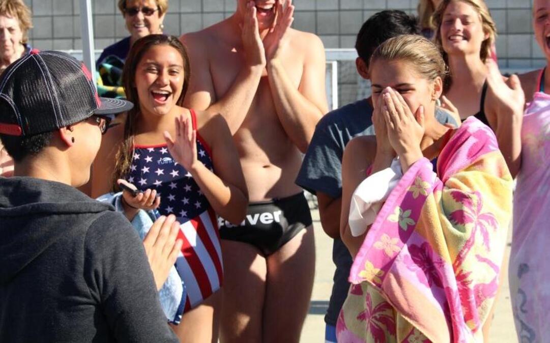 Buchanan diver Ruslana Whiteside reacts to learning from interpreter Veronica Gamch, left, that she placed first in the junior varsity competition against Clovis　North High School.