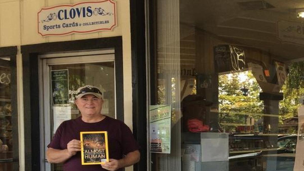 
Clovis Cards & Collectibles owner Brad Stoops displays an enlargement of the 4x5 photo purchased five years ago from his shop that is believed to depict Billy the Kid and his posse, the Regulators.
