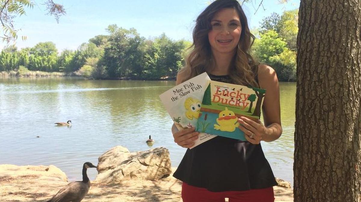 
Clovis children’s author Barbara Carpenter holds her two published books.
