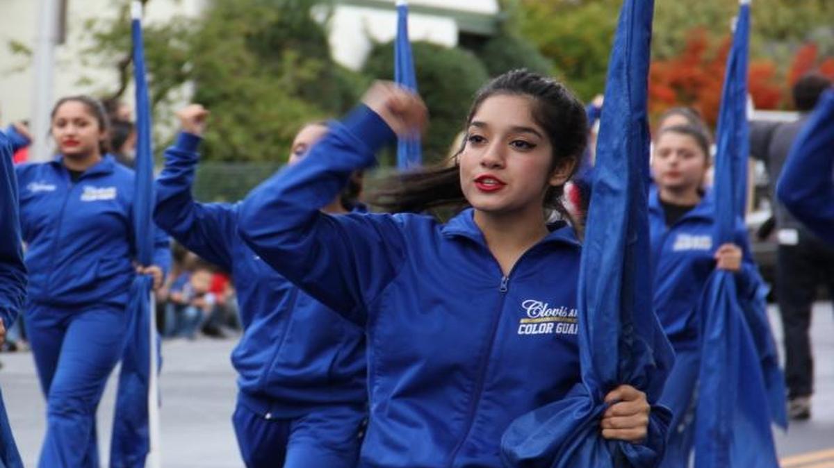 Clovis High School color guard marches in the Red Ribbon Parade.
