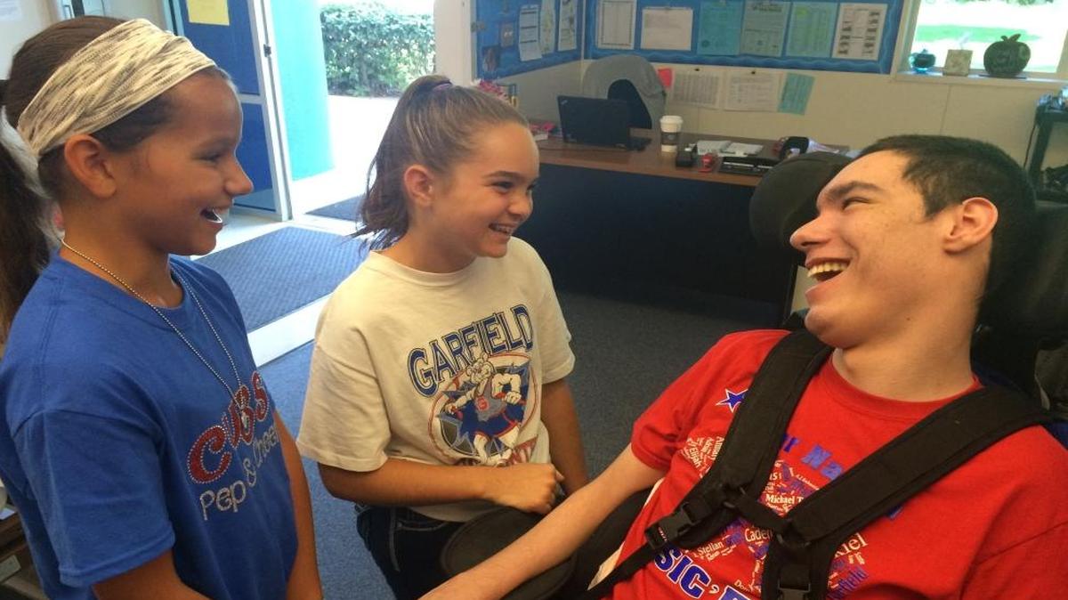 Garfield sixth graders Selah Costi and Anabelle Aguilar volunteer during recess to be peer buddies to students in the Garfield Center, like 18-year-old Austin Guizar.