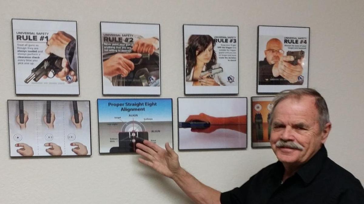 NRA-certified instructor Dennis Bushnell shows part of his teaching material for his classes at Suquie’s Treasures.