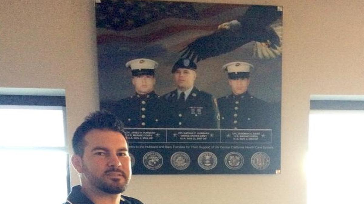 
Austin Brock, president of Hubbard-Baro Memorial, stands in the rehabilitation room in Fresno’s Veterans Affairs Medical Center. The room was dedicated to Jared and Nathan Hubbard and Jeremiah Baro, who were killed in action overseas. Their photo hangs on the wall. 
