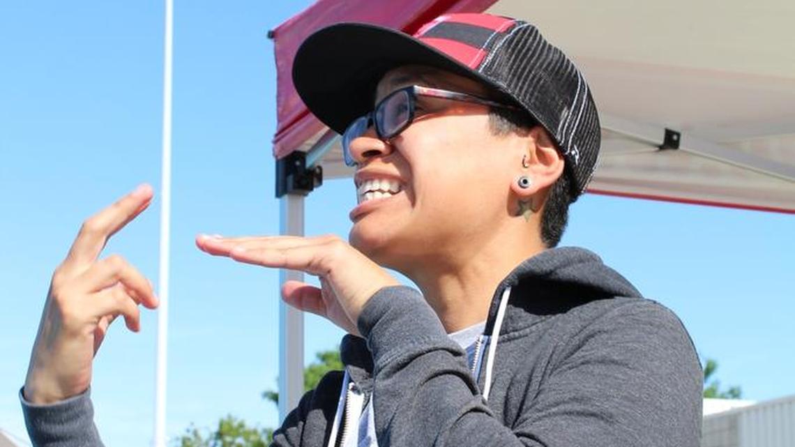 Veronica Gamch uses sign language to communicate to Ruslana Whiteside what dive to perform in a competition at Buchanan High School.