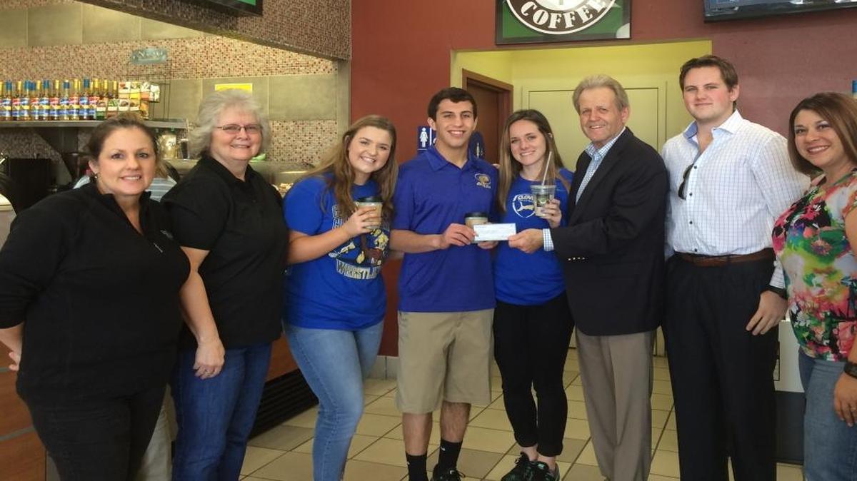 Rare Earth Coffee, Inc. employees presented Clovis High leadership students with a check for $500 last week for winning a School Spirit Challenge. From left are coffee rep Barbara Wondergem, operations manager Susan Flynn, junior Ronnie Lee, seniors Jared Hill and Ally Cooper, Rare Earth president Ernie Beal, marketing vice president Trevor Beal and accountant Andrea Alatorre.