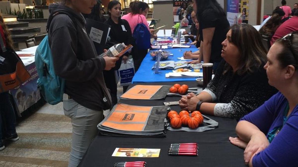 Angelina Gomez, who became a mother at age 16, speaks with representatives from Central Valley Regional Center during the 31st annual Fresno County Teen Parent Conference on Feb. 22.