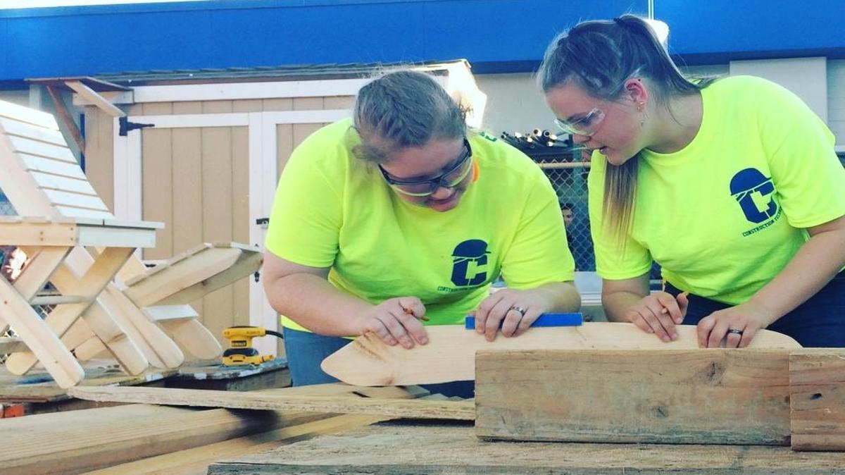 Lavenia Reed, a junior, and Sydney Barber, a sophomore, work on building a chair.