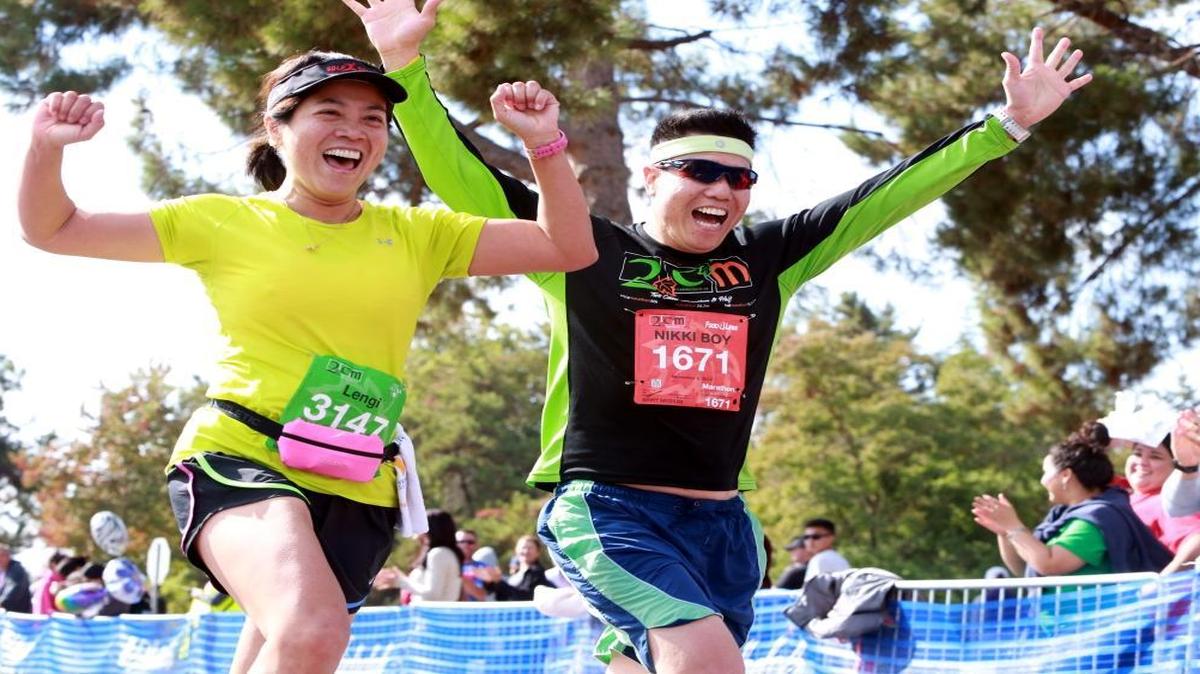 Lalaine Torres, left, and Dennis Tiu run in last year’s Two Cities Marathon & Half.