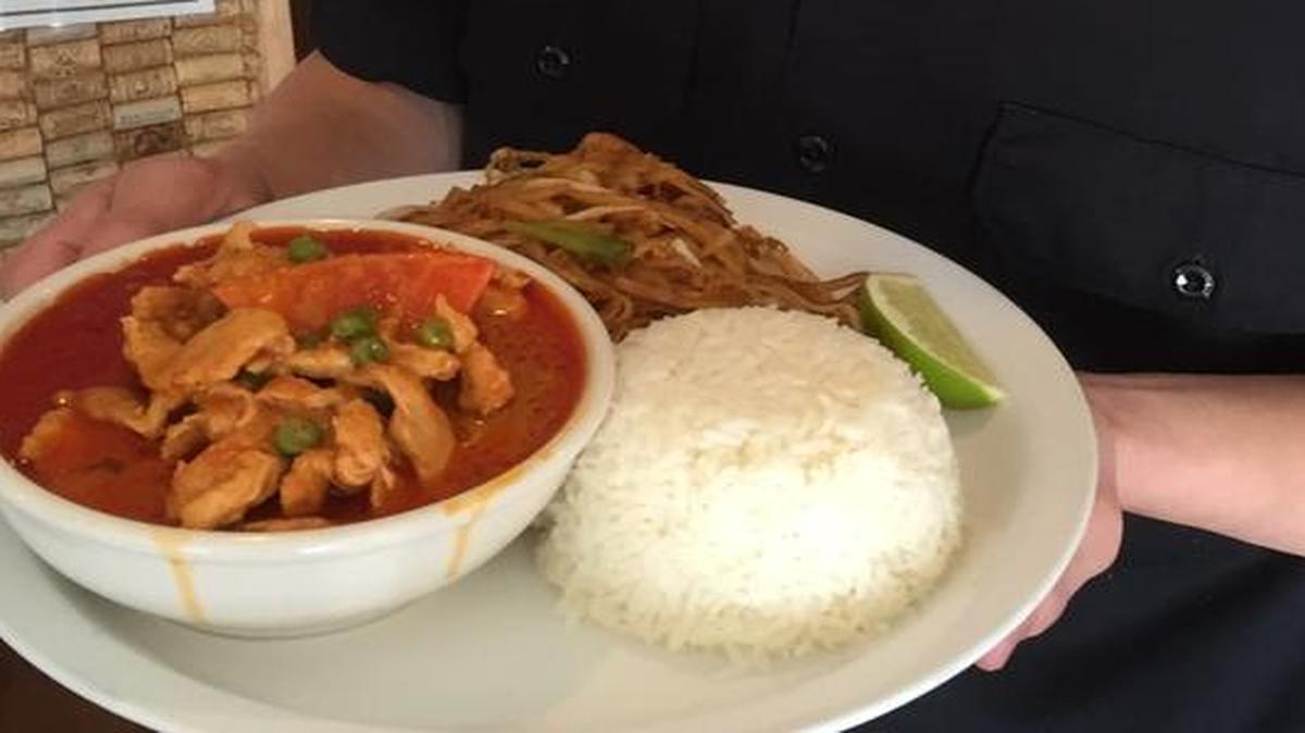 Nicholas Xiong, a server at Thai Country Restaurant, holds a Panang Special, one of two specials always on the menu.