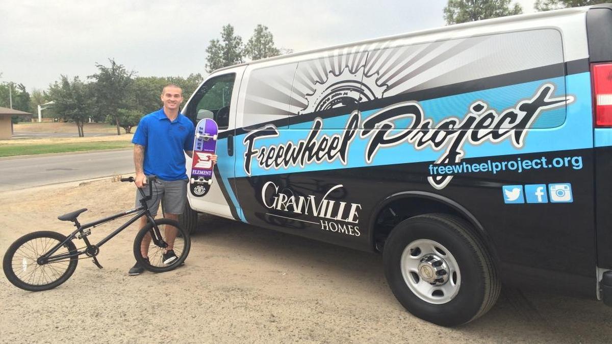 
Freewheel Project founder Tony Hoffman displays the Haro BMX bike and Element skateboard that participants can earn.
