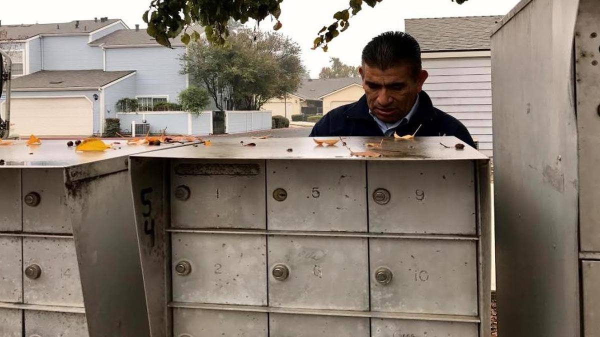Clovis letter carrier Angel Gomez delivers residential mail in one of the neighborhoods on his route.